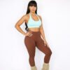 Woman wearing mocha brown high-waisted sculpt leggings with side pocket and mint sports bra